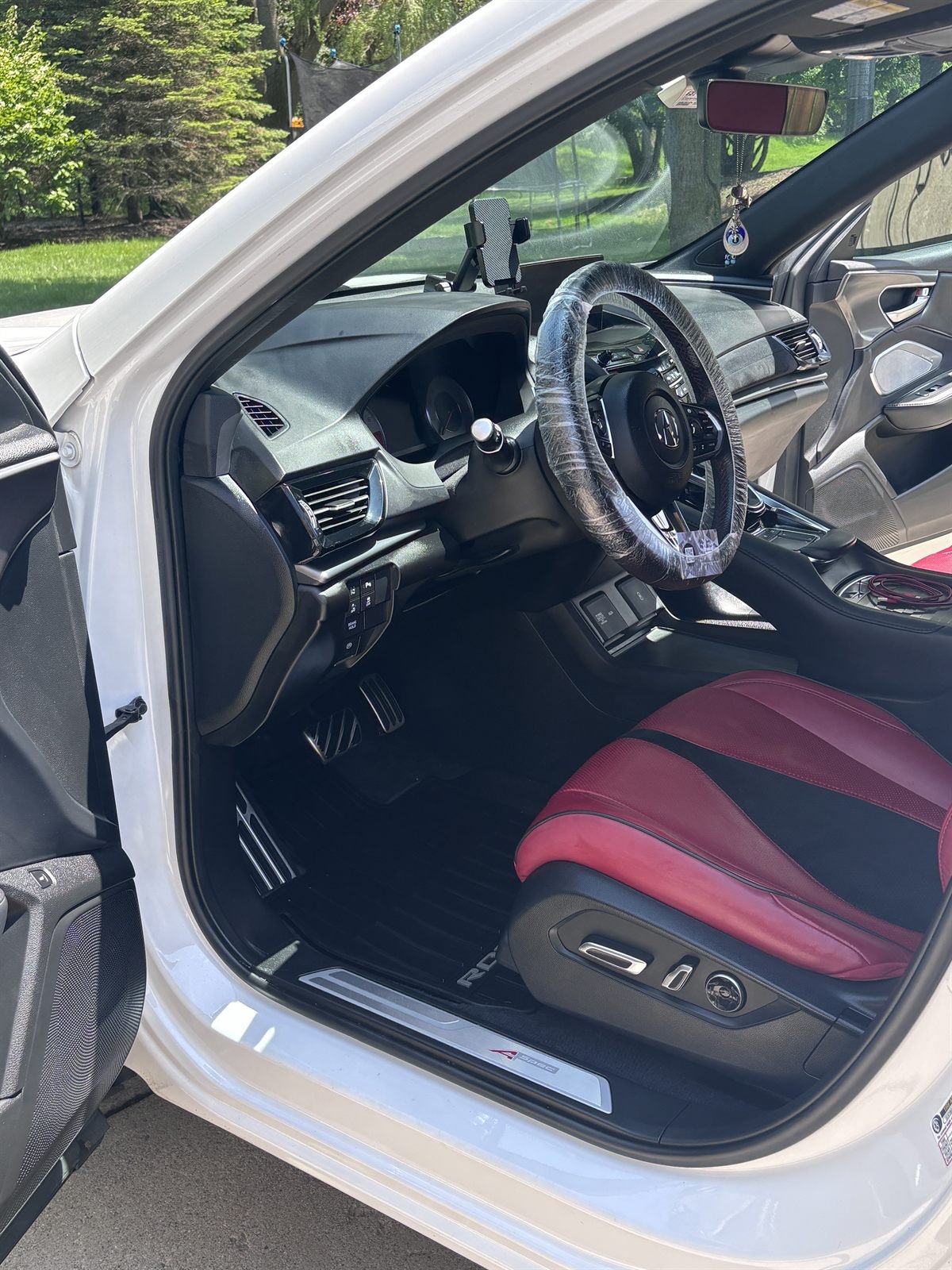 After detailing: spotless passenger-side interior with red leather cleaned by Buffalo Diamond Detailing