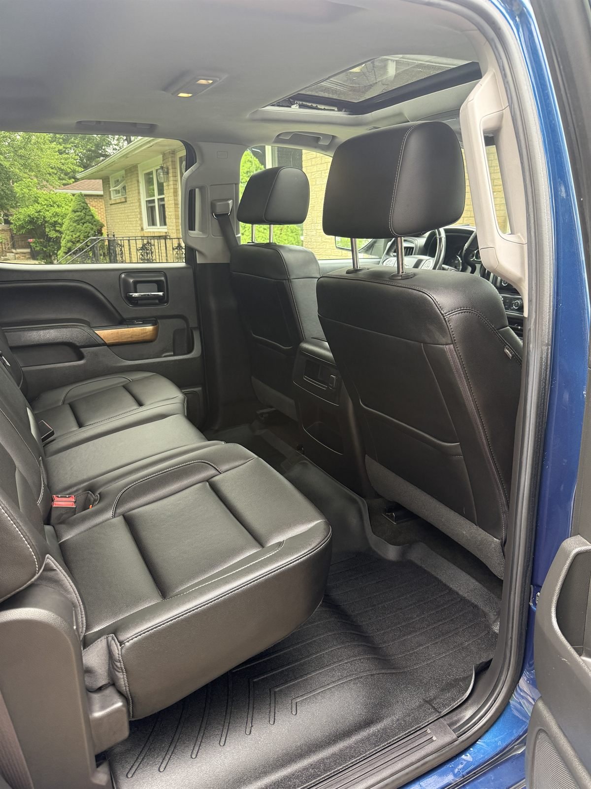 Brown leather back seats deep-cleaned in a detailed truck
