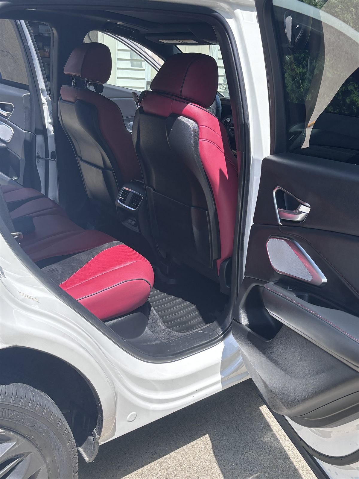 Detailed back seat with red leather in a white SUV