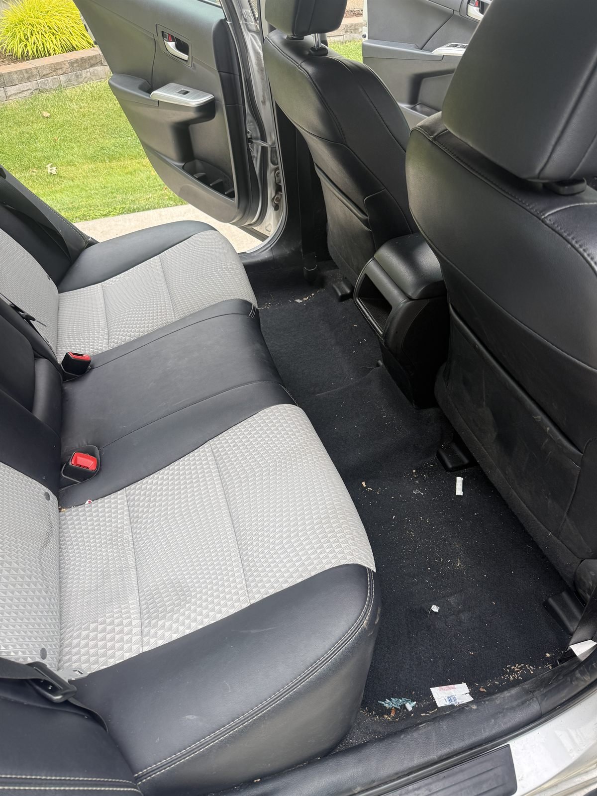 Before detailing: dusty rear seats and floor of a sedan