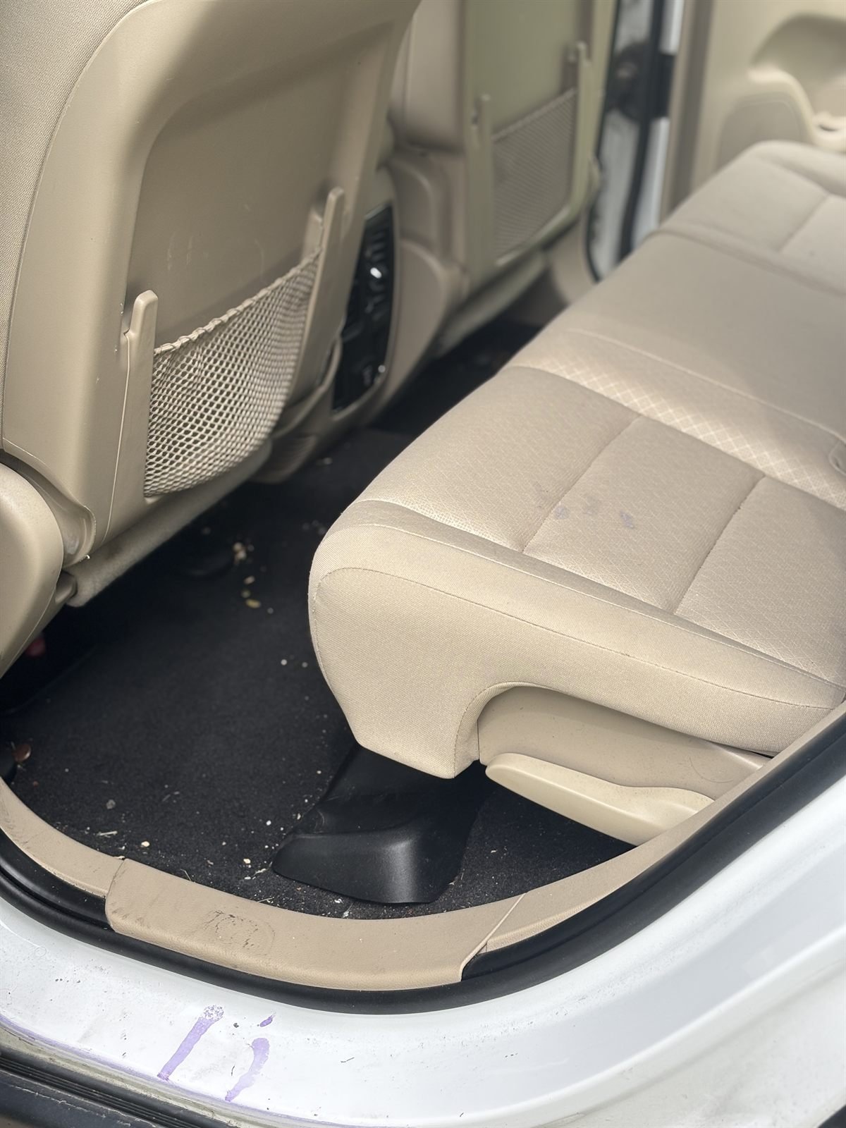 Before detailing: debris on the rear seats and floor of an SUV