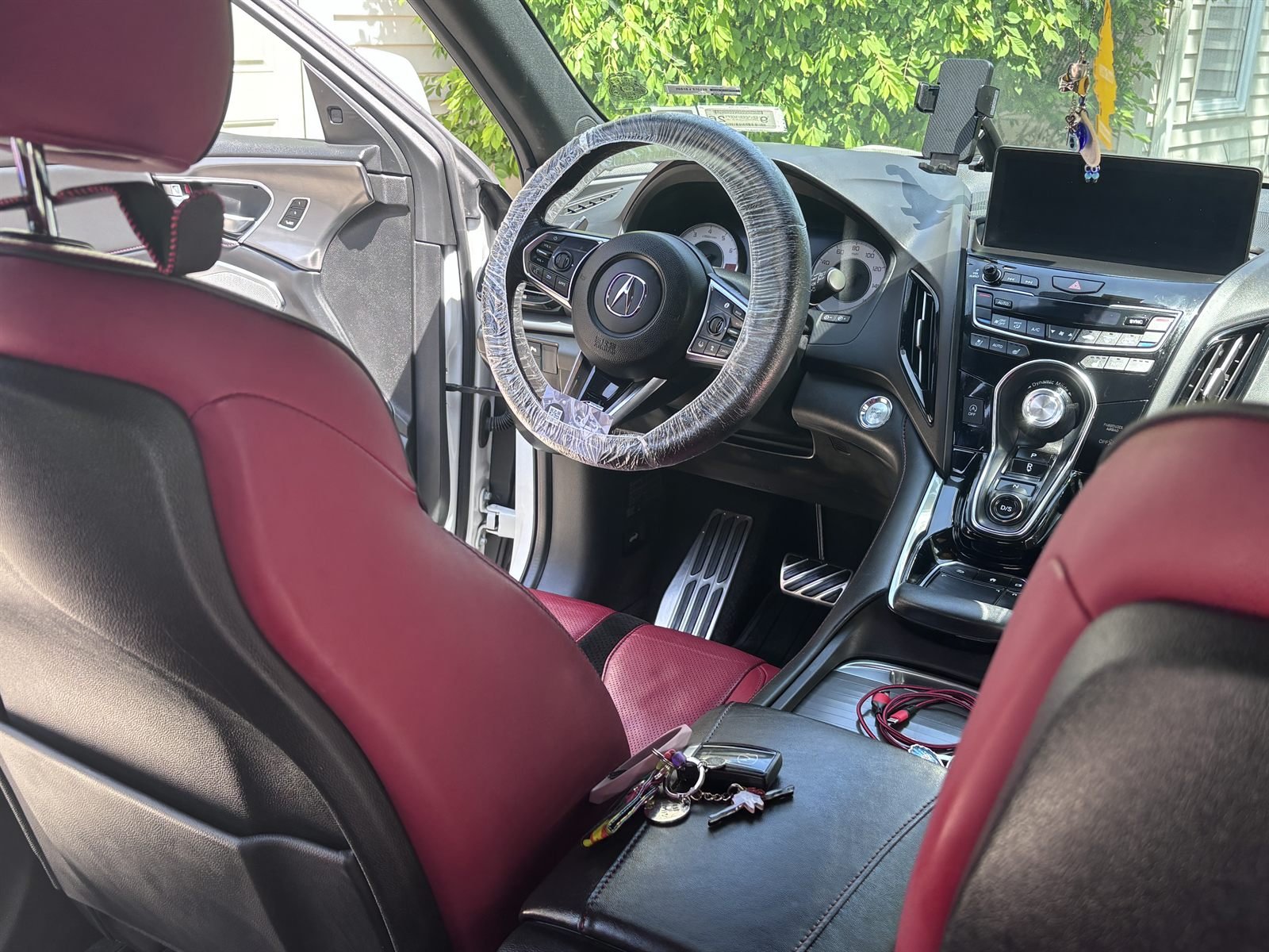 Detailed Acura interior with red leather seats, dashboard and center console