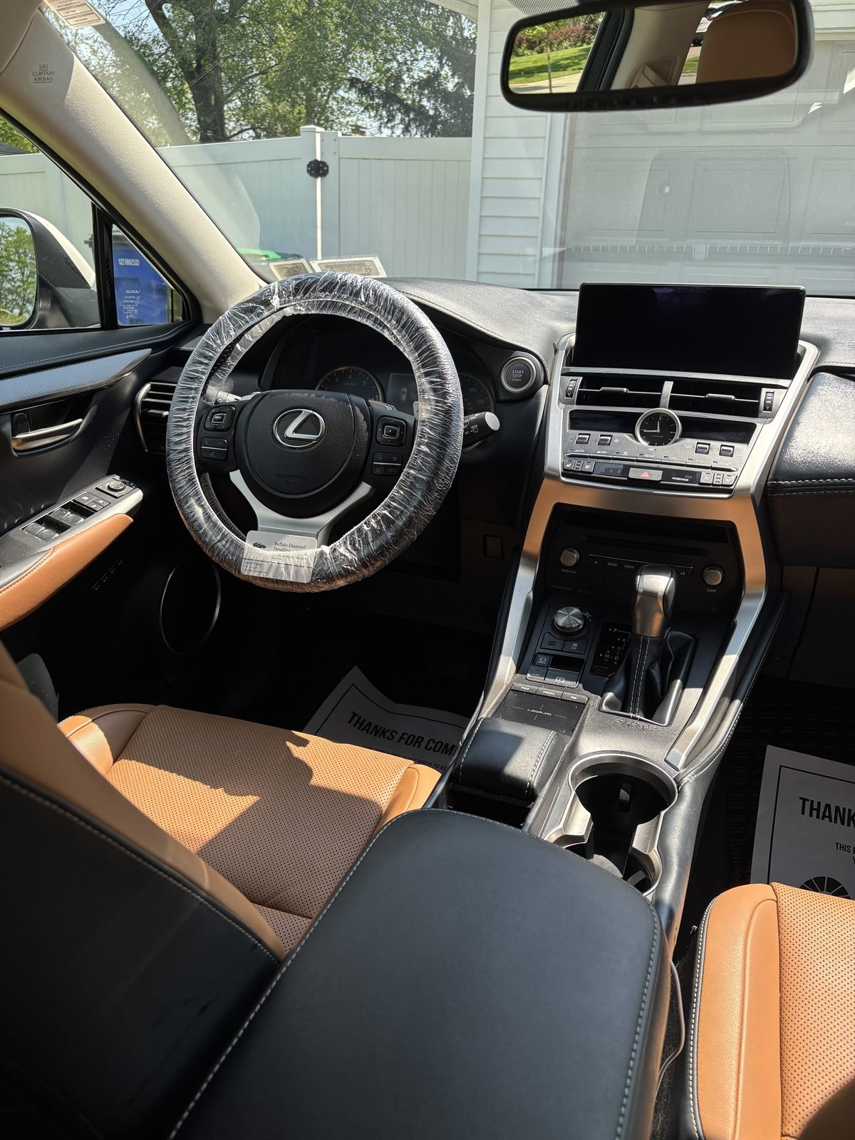 Detailed Lexus interior &mdash; console, infotainment screen and leather seats
