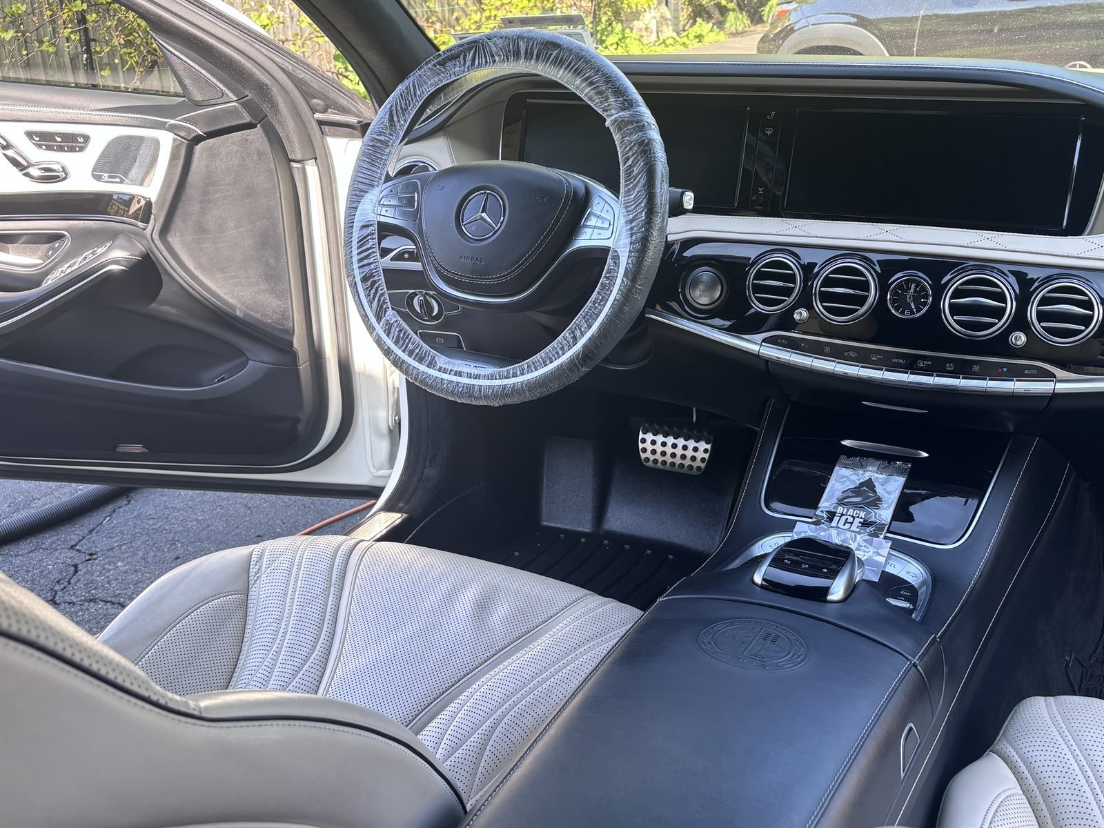 Detailed Mercedes interior &mdash; dashboard, console and white leather seats