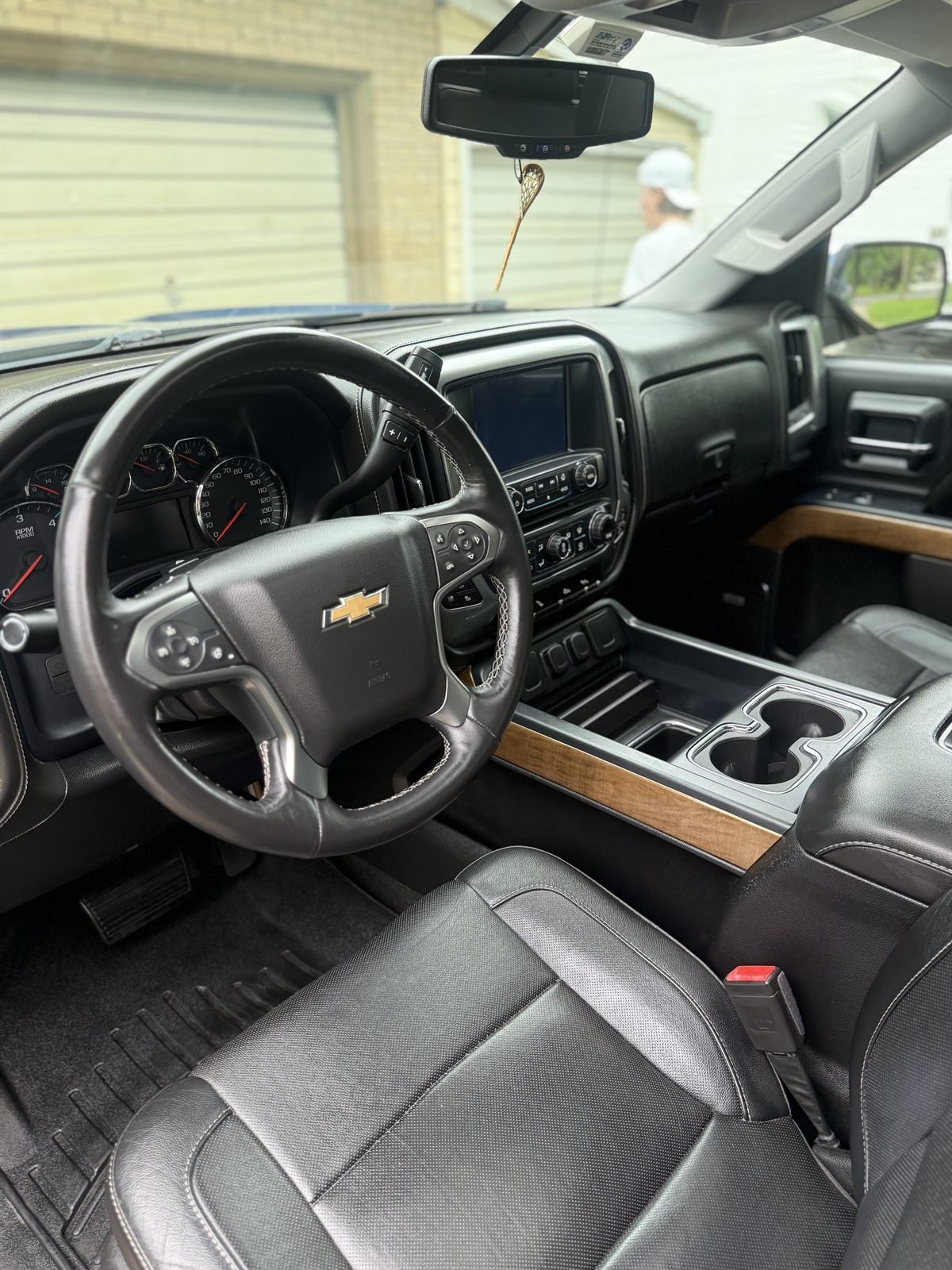 Detailed Chevrolet truck interior &mdash; console, dash and black leather
