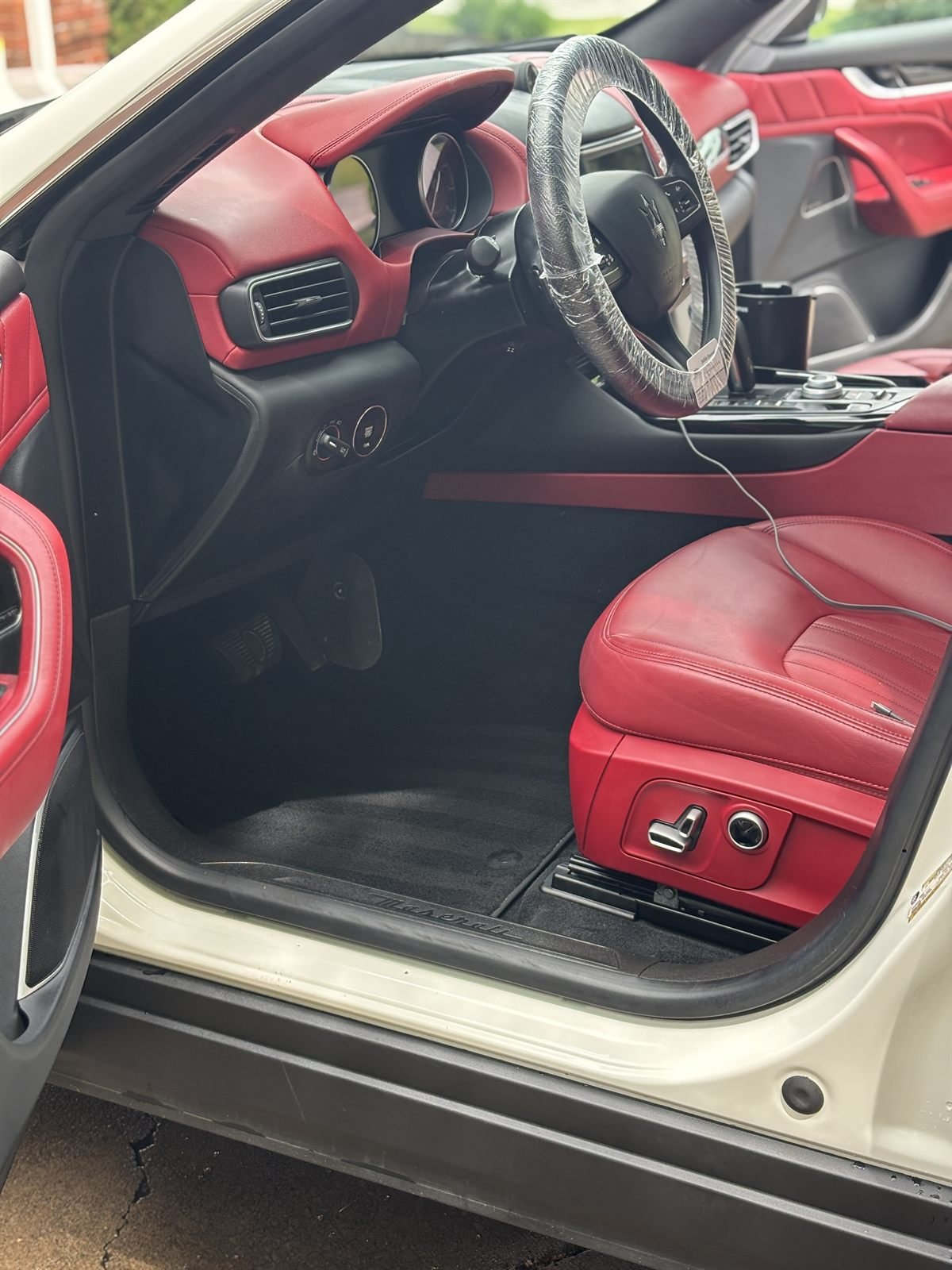 Detailed driver-side interior with red leather seats
