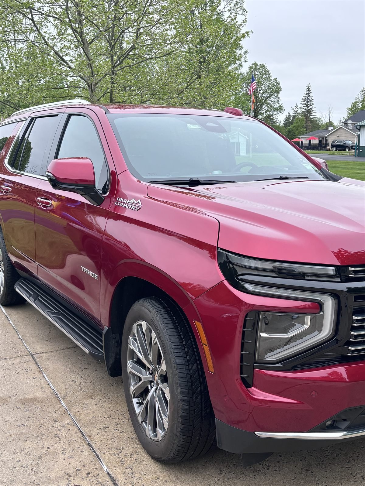 Freshly washed red Chevrolet Tahoe in a driveway