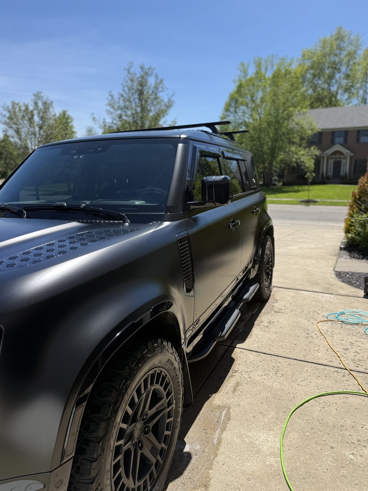 Matte-black Land Rover Defender detailed, rear three-quarter view