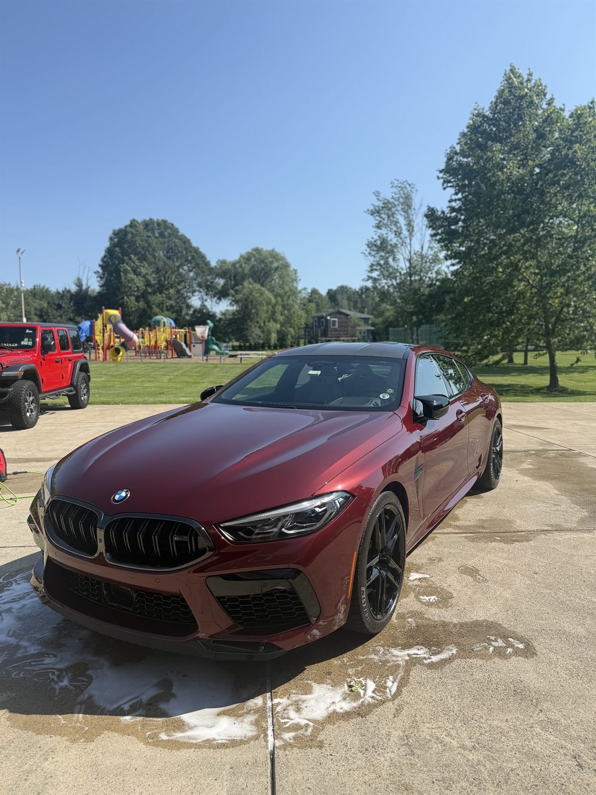 Burgundy BMW M8 clean and glossy after an exterior detail
