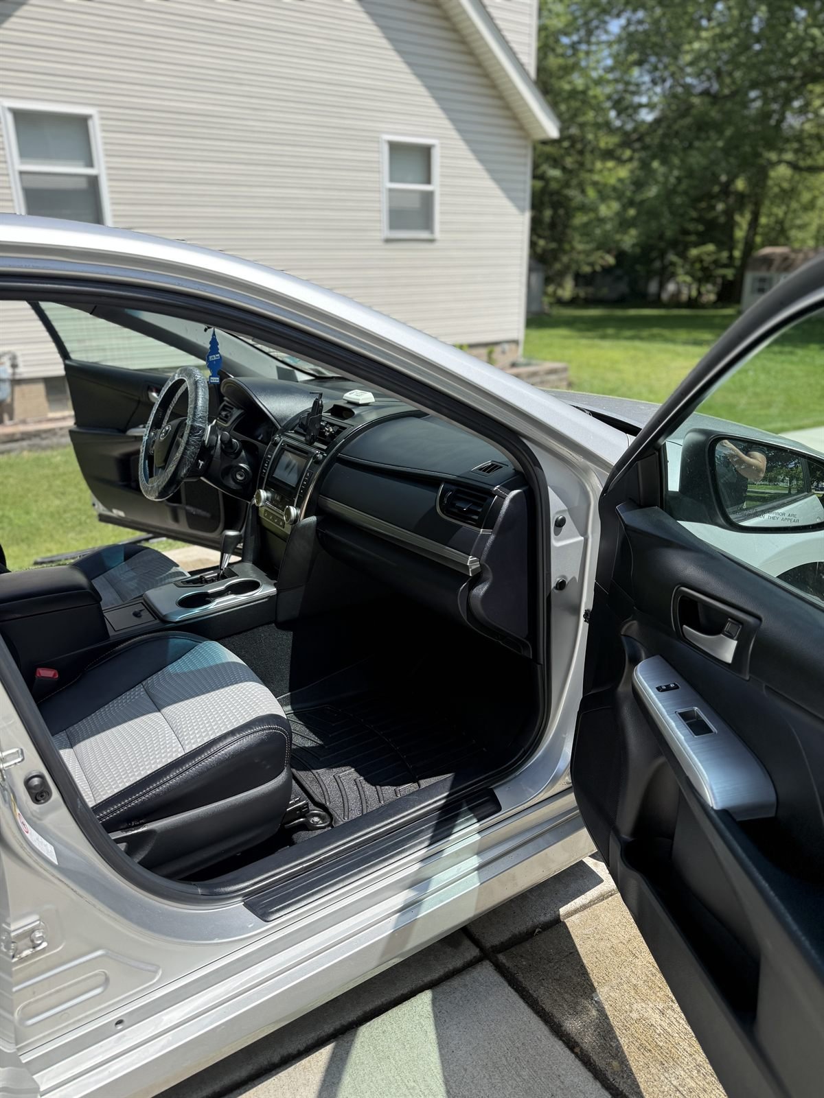 Detailed passenger-side interior of a sedan, seats and door cleaned