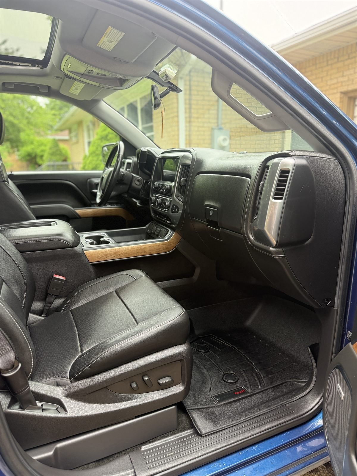 Detailed passenger-side interior of a truck &mdash; leather seats and wood trim