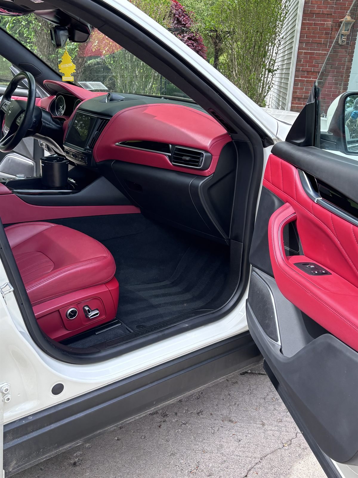 Detailed passenger-side interior with red leather seats